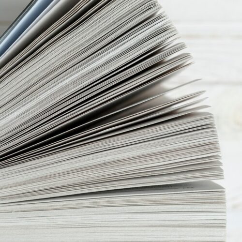 close-up-book-paper-with-white-background_23-2148255919